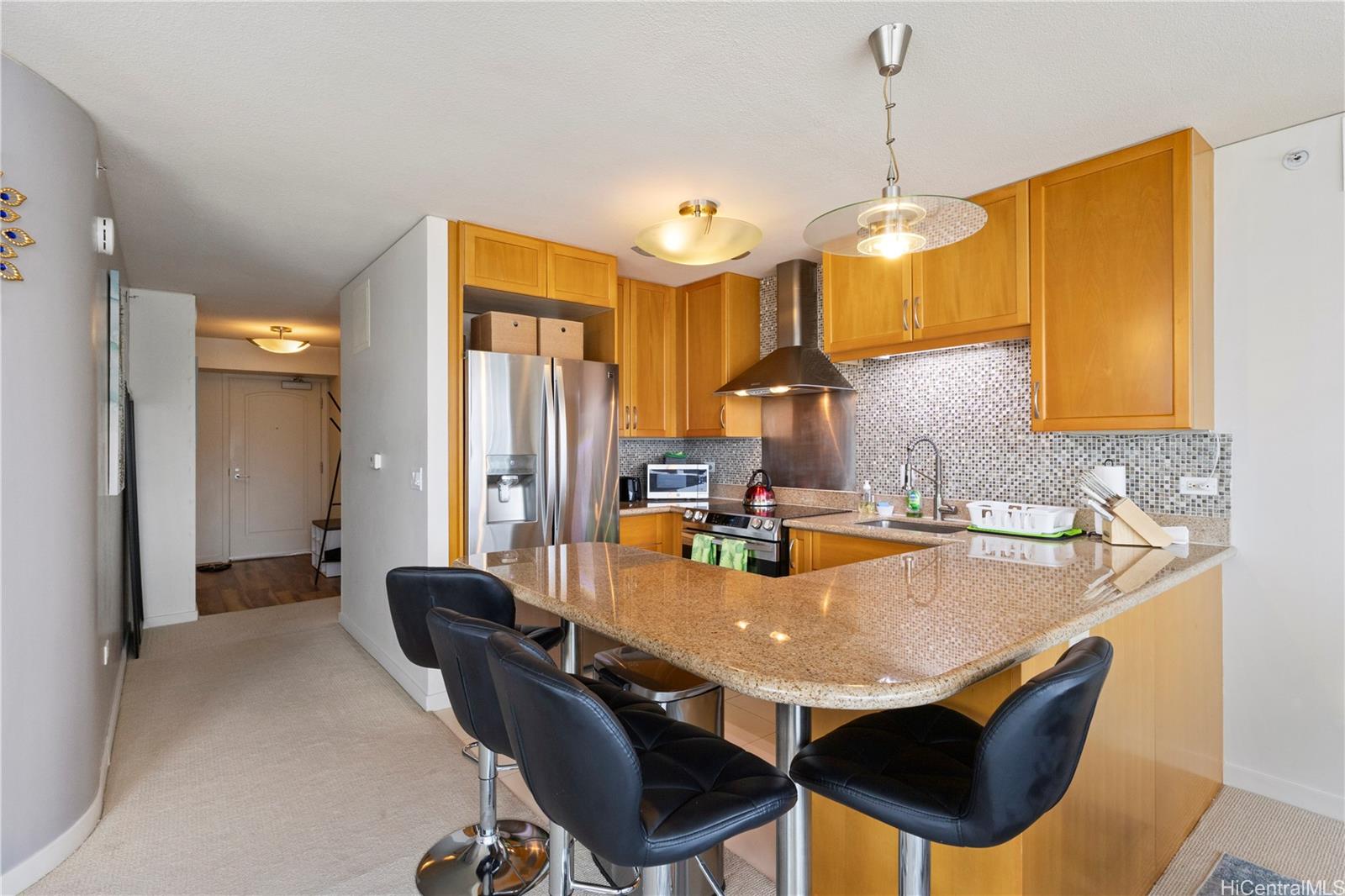 1288 Kapiolani Boulevard, Unit I4203 Honolulu, HI 96814 - Photo 9 of 25 a dining table chairs and a chandelier