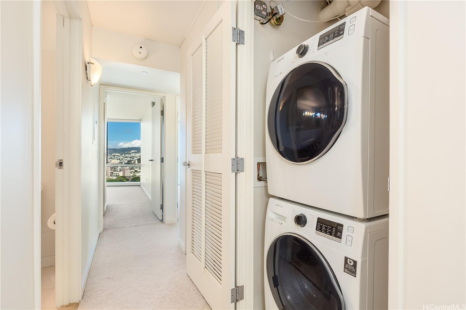 1288 Kapiolani Boulevard, Unit I4203 Honolulu, HI 96814 - Photo 10 of 25 a view of a hallway with washer and dryer