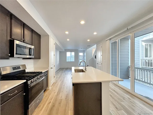 a kitchen with a sink stainless steel appliances and cabinets