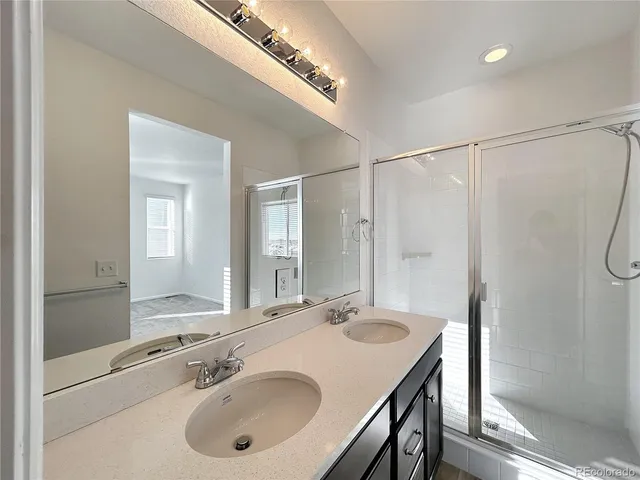 a bathroom with a sink double vanity and a mirror