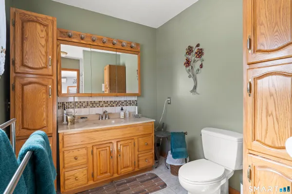 a bathroom with a granite countertop sink a mirror and a shower