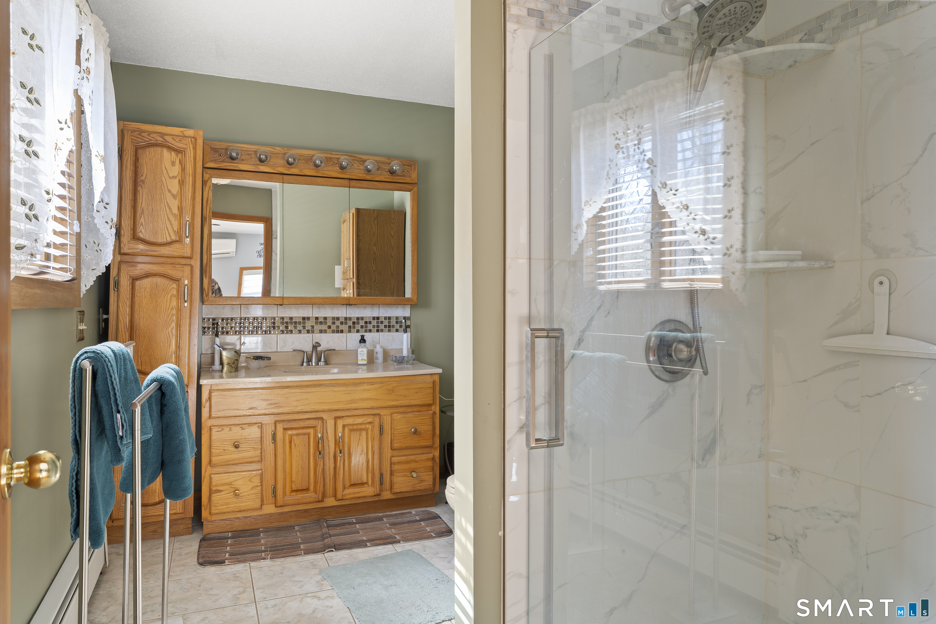 172 Old Willimantic Road Columbia, CT 06237 - Photo 15 of 39 a bathroom with a granite countertop sink a mirror and a shower
