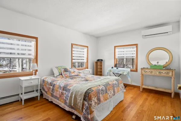 a bedroom with bed and window