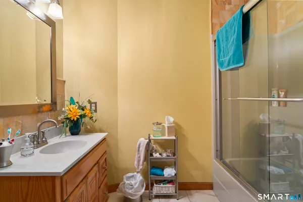 a living room with furniture a chandelier and a floor to ceiling window
