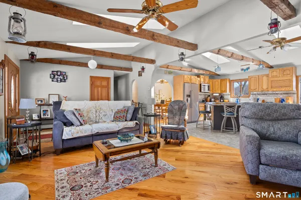 a living room with furniture and wooden floor