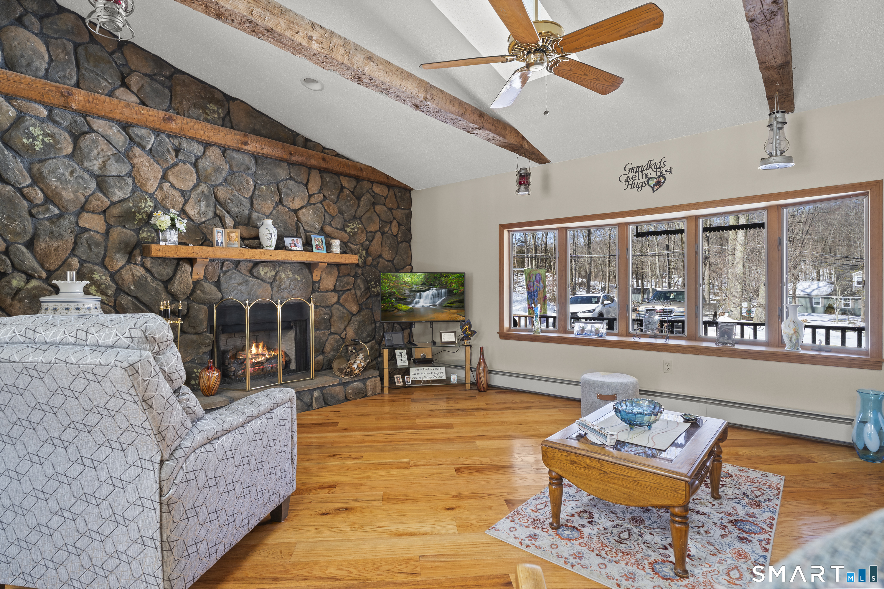 172 Old Willimantic Road Columbia, CT 06237 - Photo 24 of 39 a living room with furniture a chandelier and a floor to ceiling window