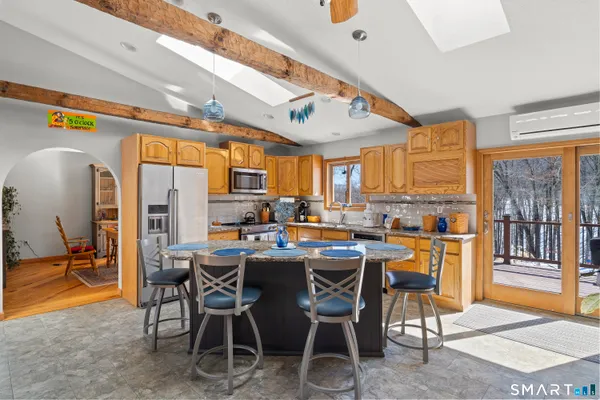 a kitchen with stainless steel appliances granite countertop a stove a sink and a refrigerator