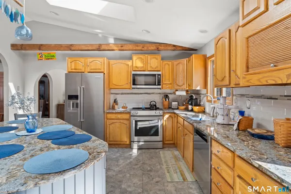 a dining room with furniture a window and a chandelier