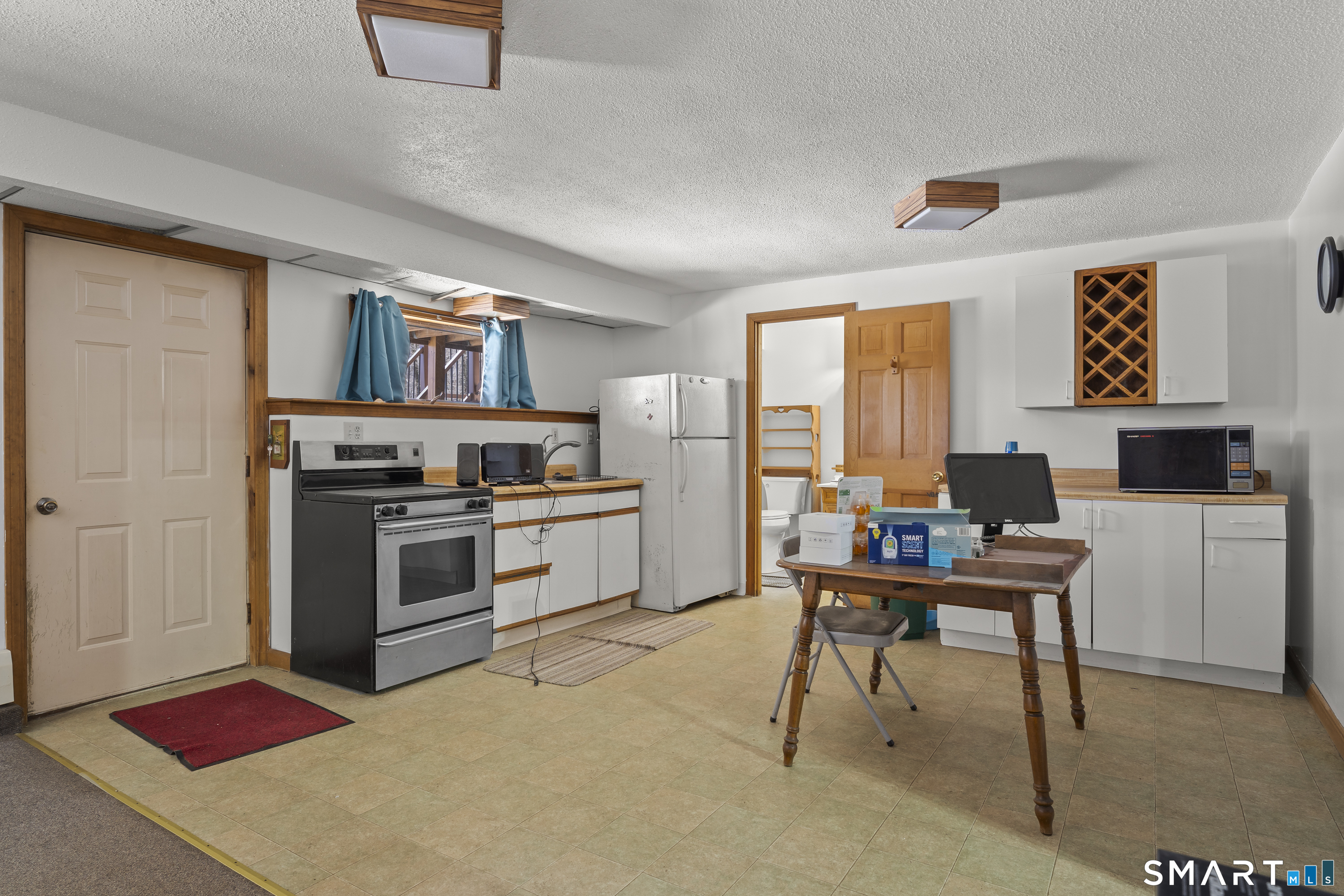172 Old Willimantic Road Columbia, CT 06237 - Photo 33 of 39 a work place with stainless steel appliances kitchen island furniture and a window