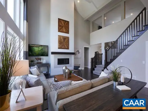 a living room with furniture a fireplace and a window