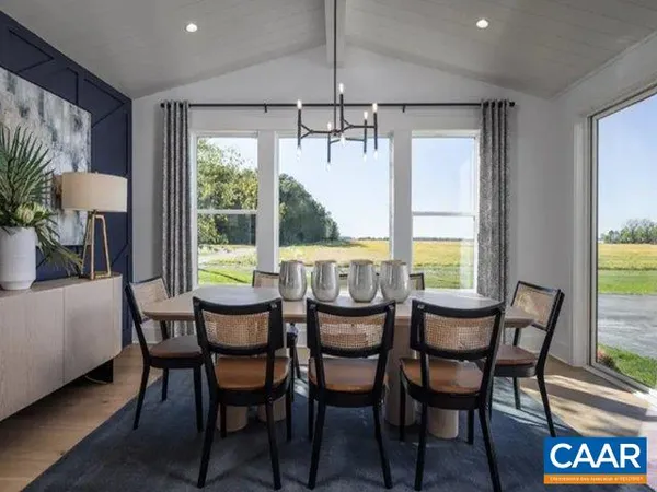a dining room with furniture window and wooden floor