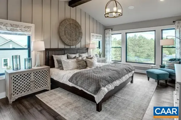 a spacious bedroom with a bed and a large window