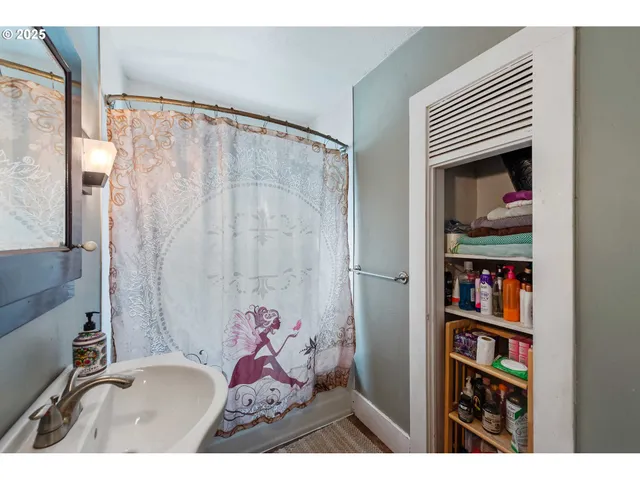 a bathroom with a sink and a shower curtain