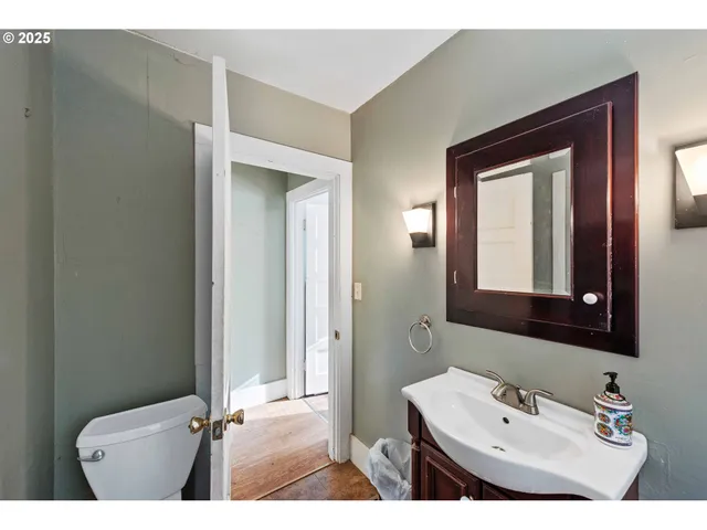 a bathroom with a sink a mirror and a toilet