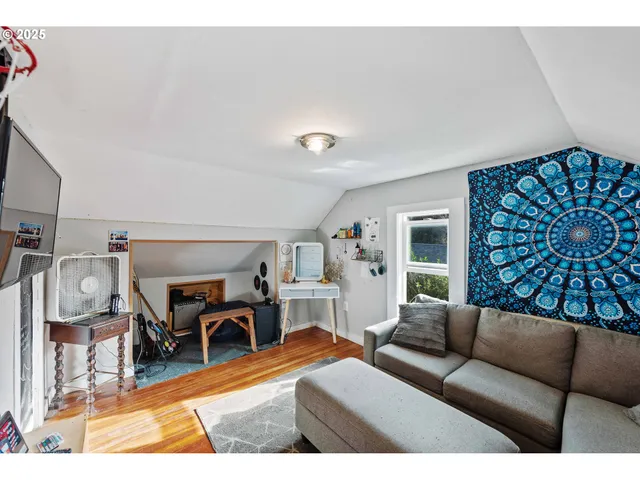 a living room with furniture a rug and gym equipment