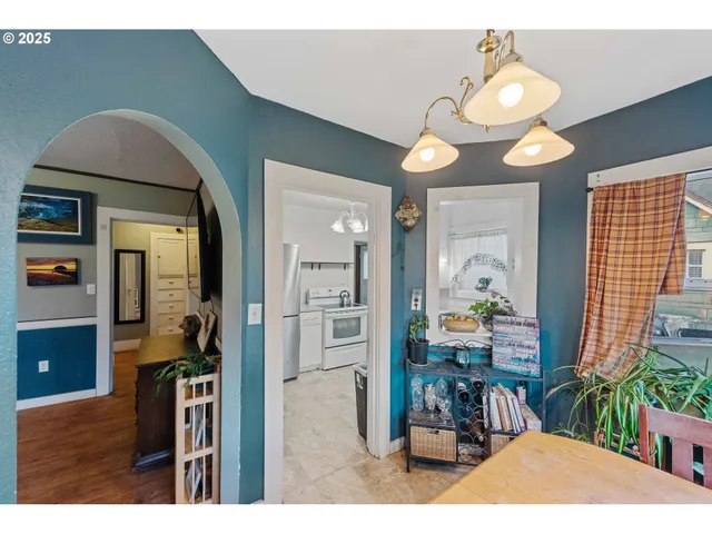 a view of a dining room with furniture and chandelier
