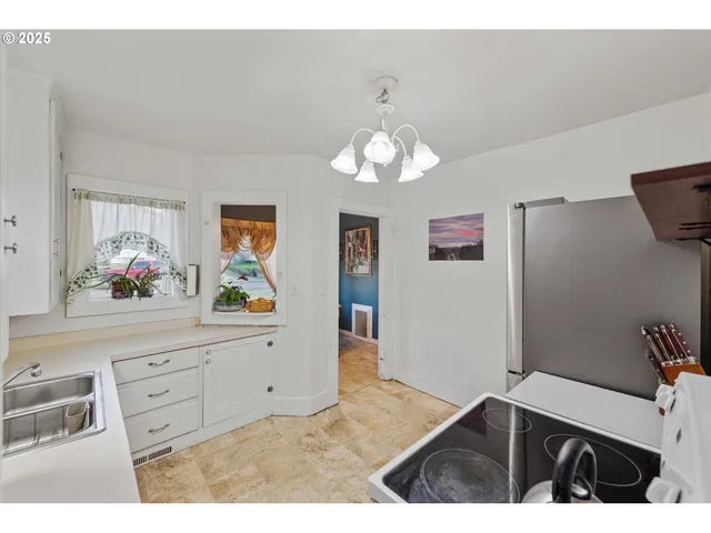 a view of a kitchen with microwave and cabinets