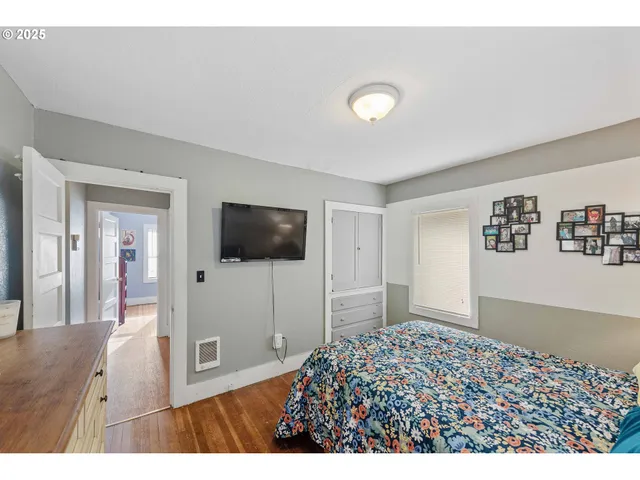 a living room with a flat screen tv and a refrigerator