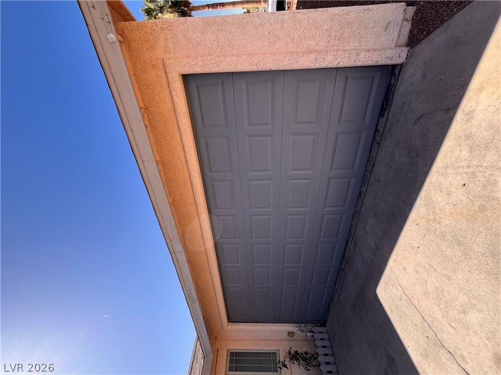 5348 Ravendale Circle Las Vegas, NV 89120 - Photo 4 of 14 Secure parking solutions with a paneled garage door and a clear concrete driveway.