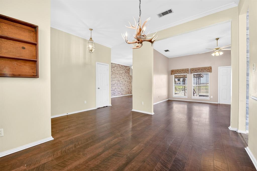 13616 Bates Aston Road Haslet, TX 76052 - Photo 13 of 36 a view of an empty room with wooden floor and a window