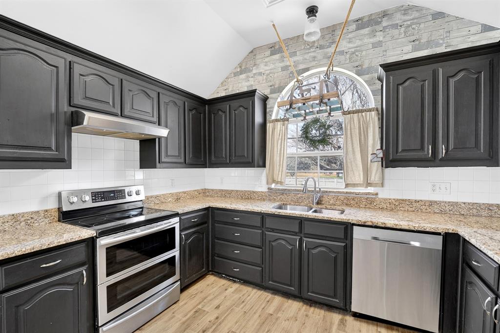 13616 Bates Aston Road Haslet, TX 76052 - Photo 20 of 36 a kitchen with stainless steel appliances granite countertop a sink stove and cabinets