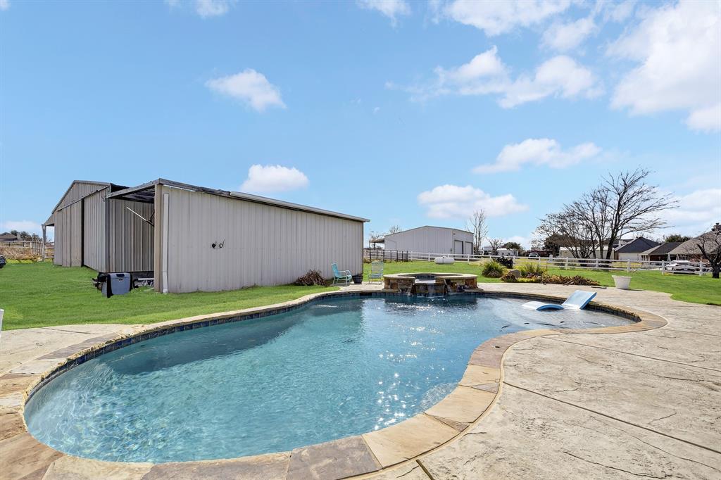 13616 Bates Aston Road Haslet, TX 76052 - Photo 36 of 36 a view of a swimming pool with a lounge chairs