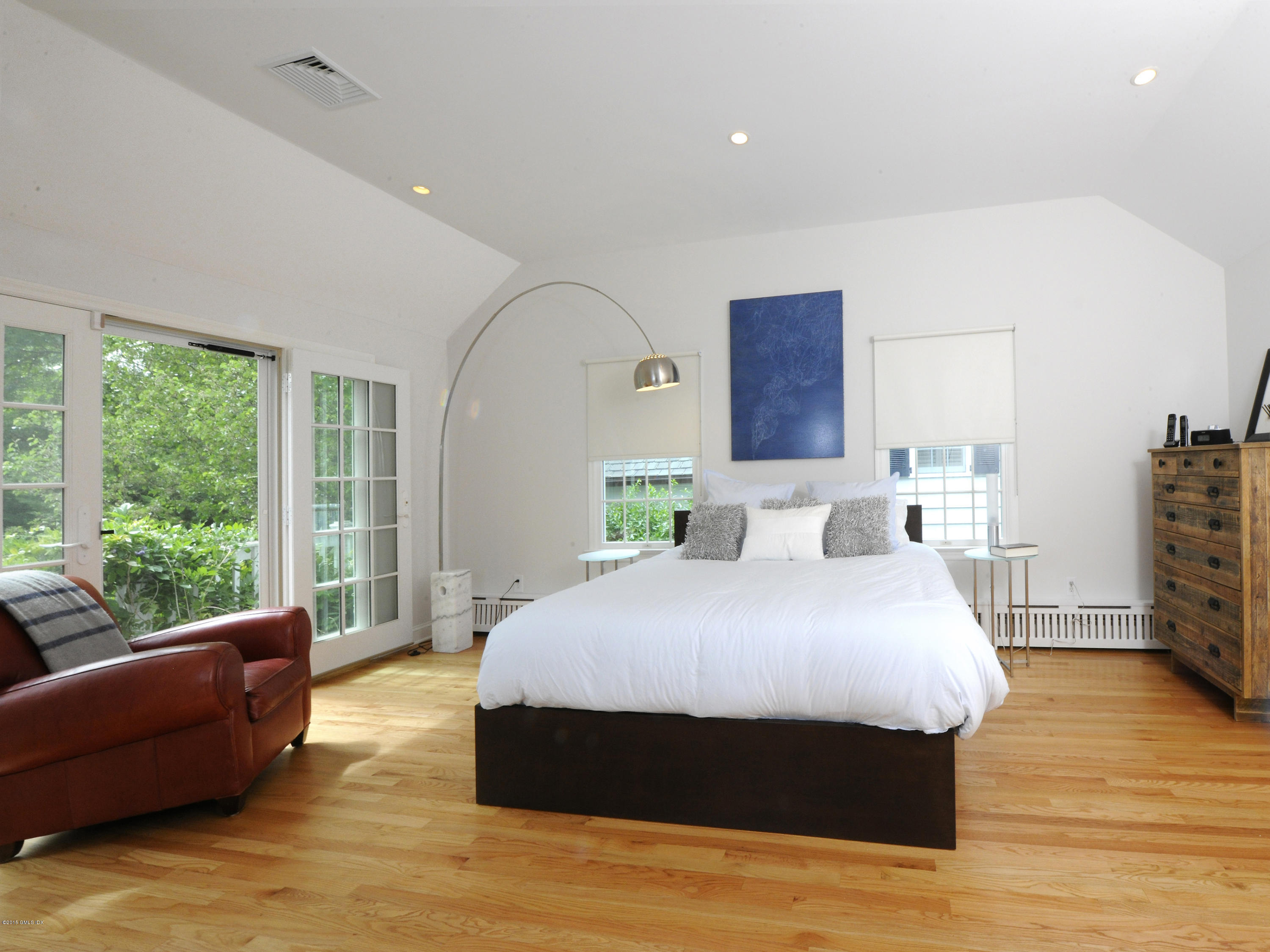 14 Spruce Street Riverside, CT 06878 - Photo 17 of 22 a spacious bedroom with a bed and wooden floor