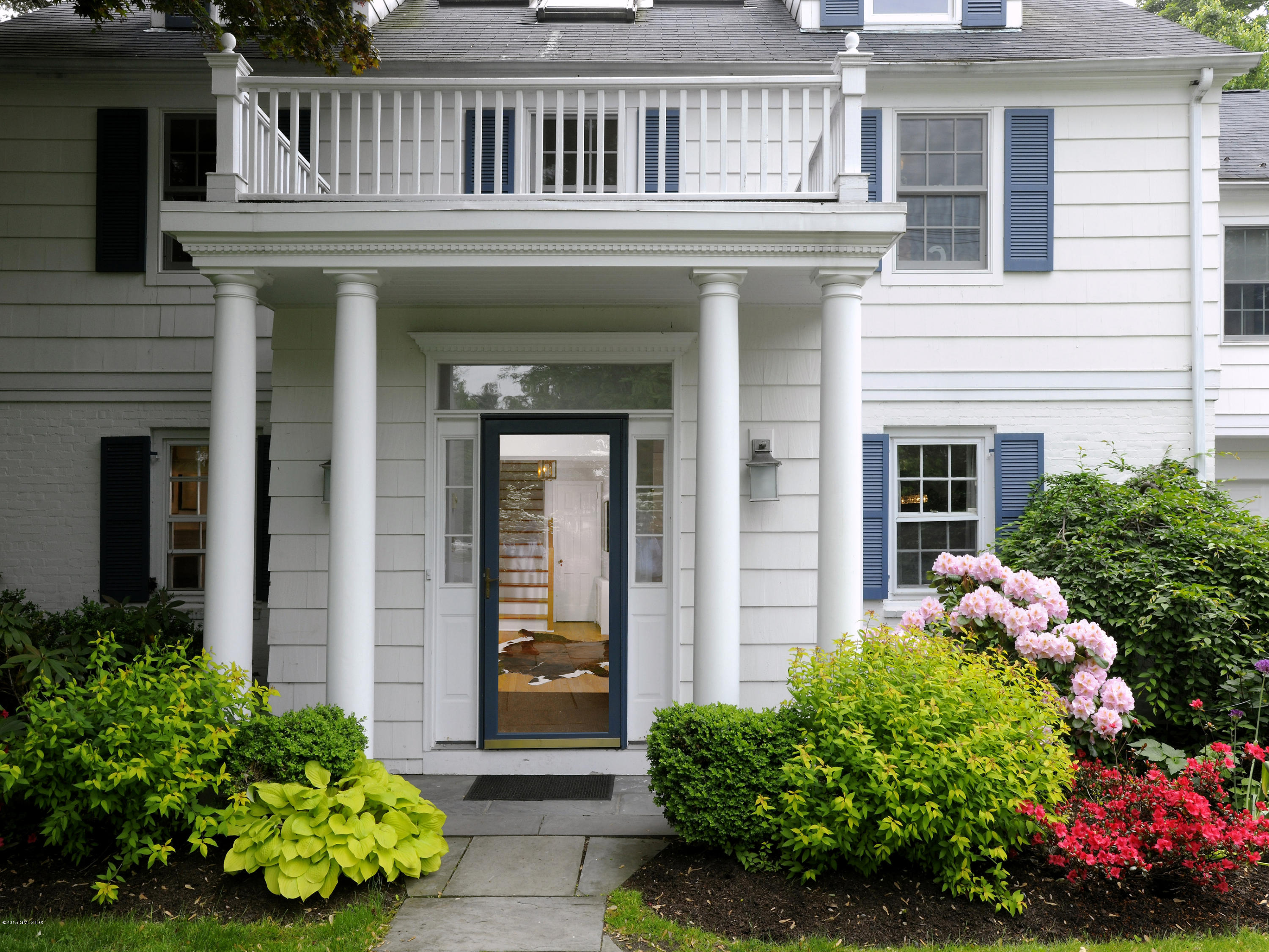 14 Spruce Street Riverside, CT 06878 - Photo 2 of 22 a front view of a house with a garden