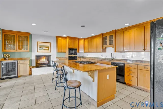 a kitchen with stainless steel appliances granite countertop a sink and a refrigerator