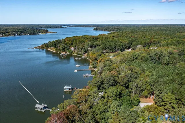 an aerial view of a houses with ocean view