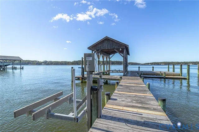 a view of a patio with dining table and chairs with wooden floor