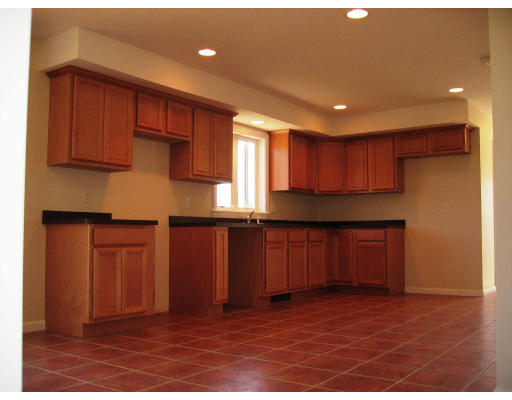 Lot 2 Oakham Road Barre, MA 01005 - Photo 11 of 16 a kitchen with granite countertop wooden cabinets a refrigerator and wooden floor
