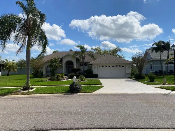 a front view of house with yard and green space