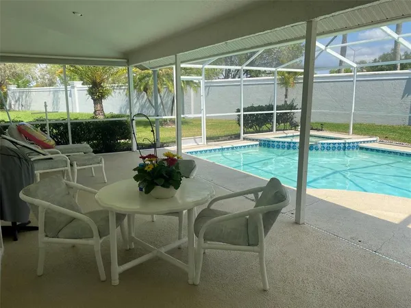 a dining room with furniture and floor to ceiling window