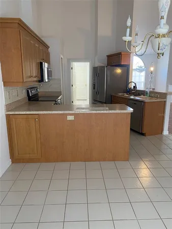 a kitchen with stainless steel appliances a sink a counter top space and cabinets