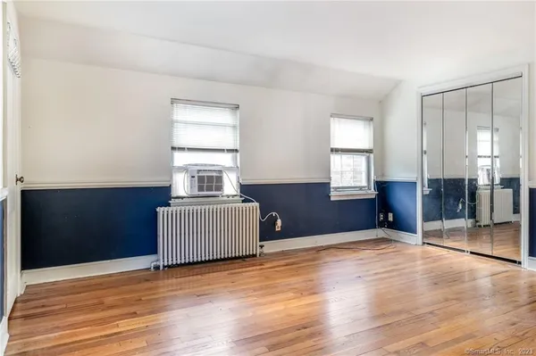 a bedroom with furniture and window
