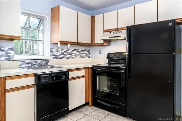 a kitchen with a sink stove and refrigerator