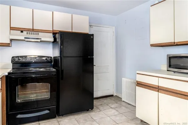 a kitchen with a refrigerator stove and cabinets