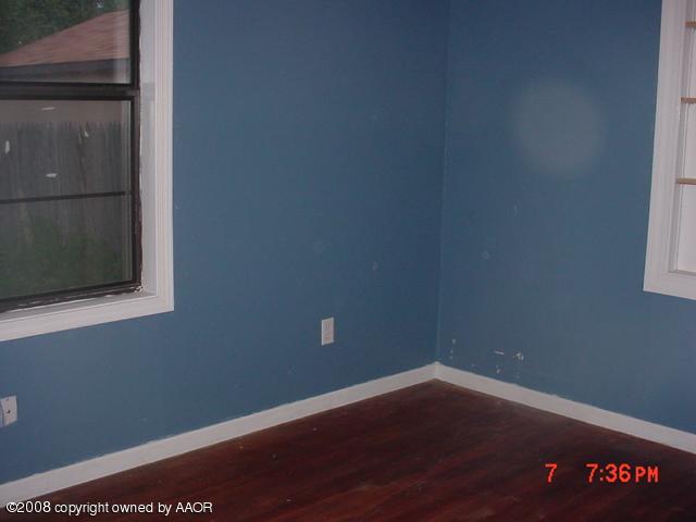 4617 Preston Street Amarillo, TX 79110 - Photo 4 of 6 a view of a small space with wooden floor and a window