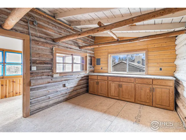 a kitchen with granite countertop a stove and cabinets