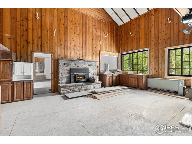 a view of an empty room with a fireplace