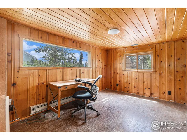a workspace room with furniture and a window