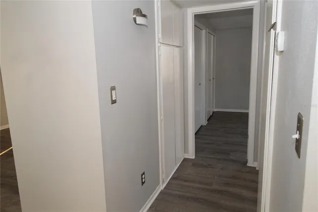 a bathroom with a granite countertop bathtub shower sink vanity and toilet