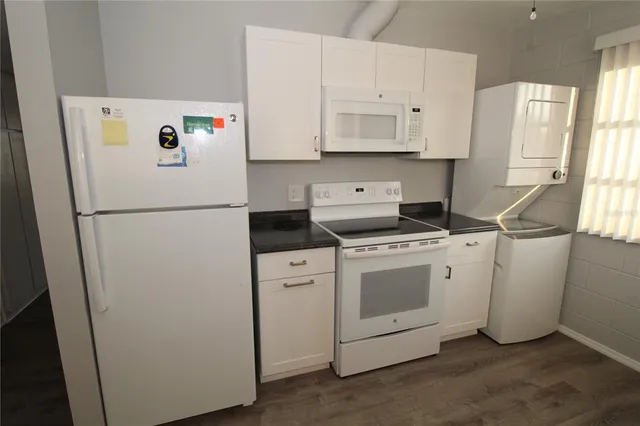 a kitchen with granite countertop a sink and a window