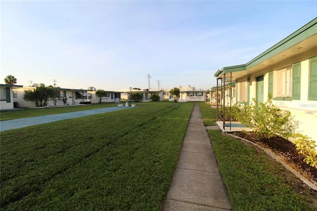 a view of a house with porch and garden