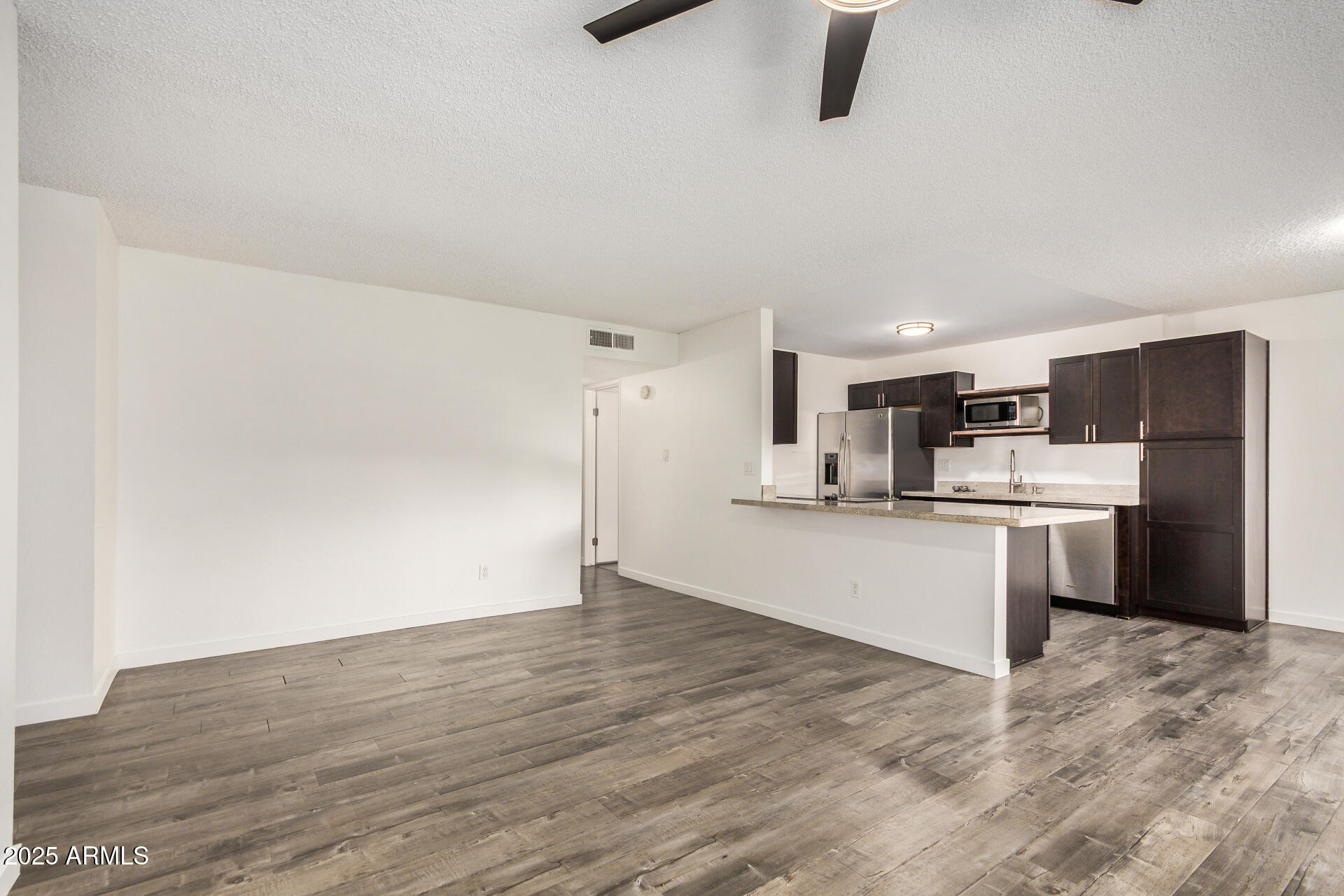 5525 East Thomas Road, Unit C4 Phoenix, AZ 85018 - Photo 11 of 34 a view of kitchen with wooden floor