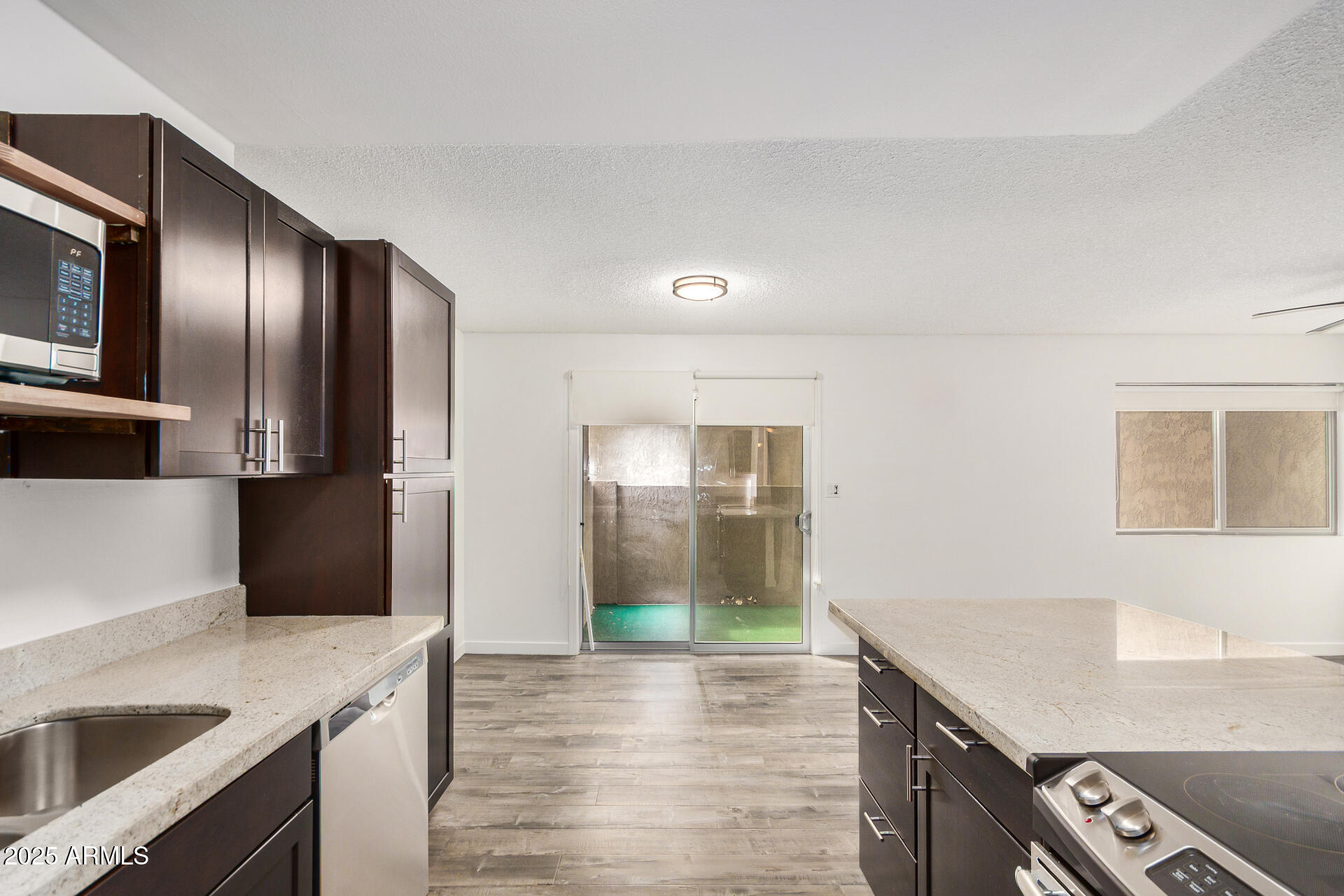 5525 East Thomas Road, Unit C4 Phoenix, AZ 85018 - Photo 13 of 34 a kitchen with stainless steel appliances granite countertop a refrigerator a sink and a stove