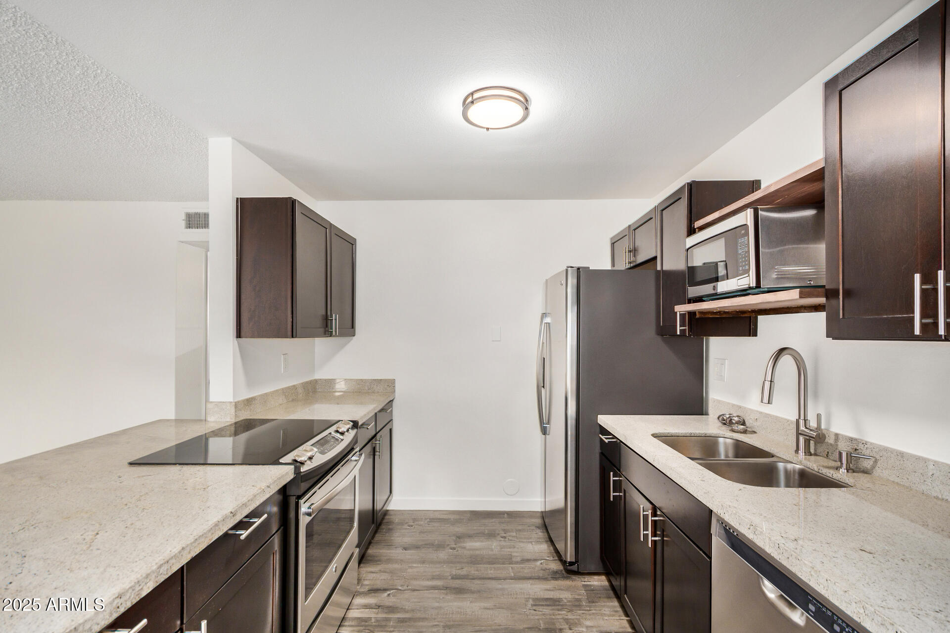 5525 East Thomas Road, Unit C4 Phoenix, AZ 85018 - Photo 16 of 34 a kitchen with stainless steel appliances granite countertop a sink stove and refrigerator