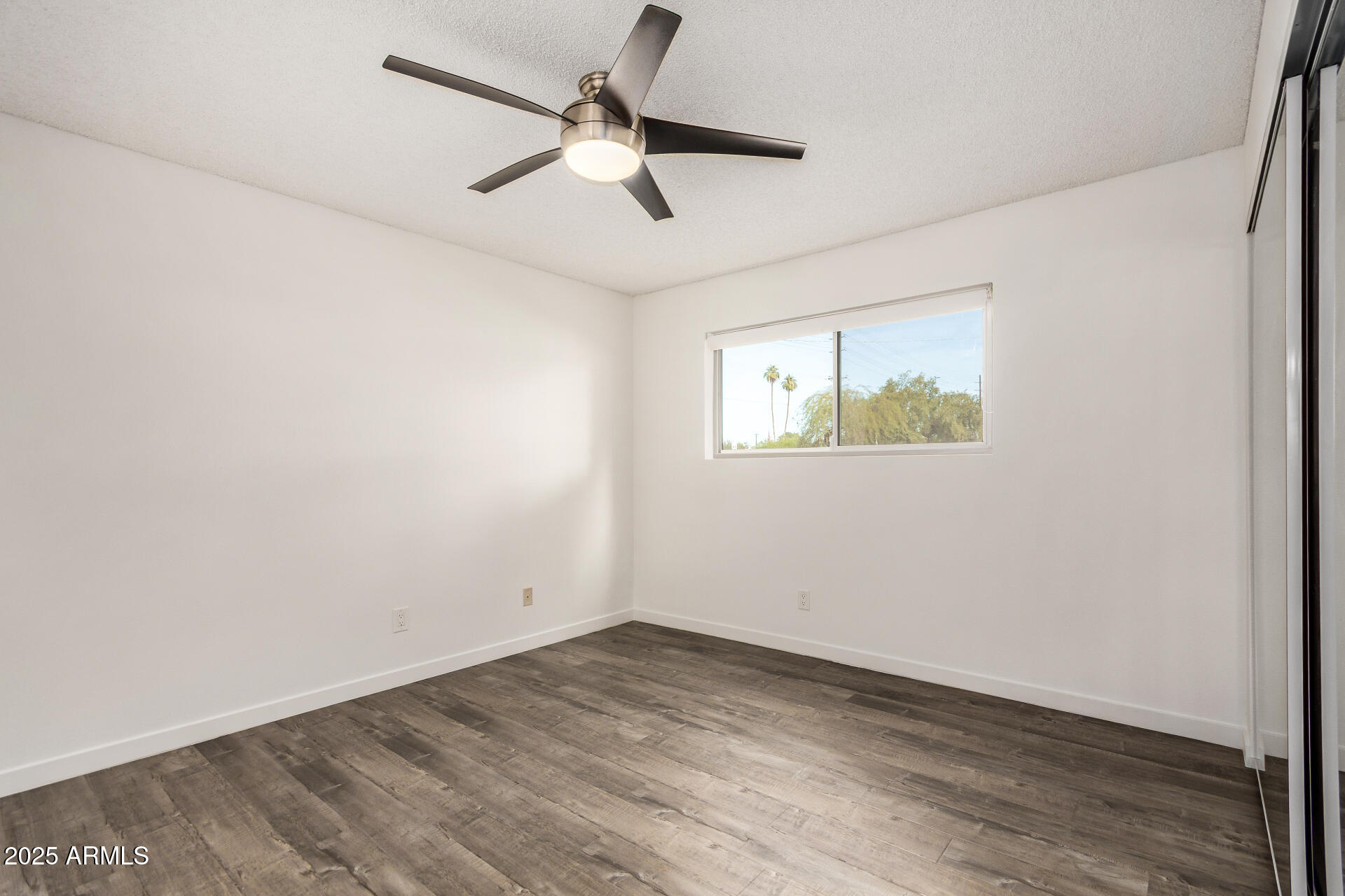 5525 East Thomas Road, Unit C4 Phoenix, AZ 85018 - Photo 19 of 34 an empty room with wooden floor and windows