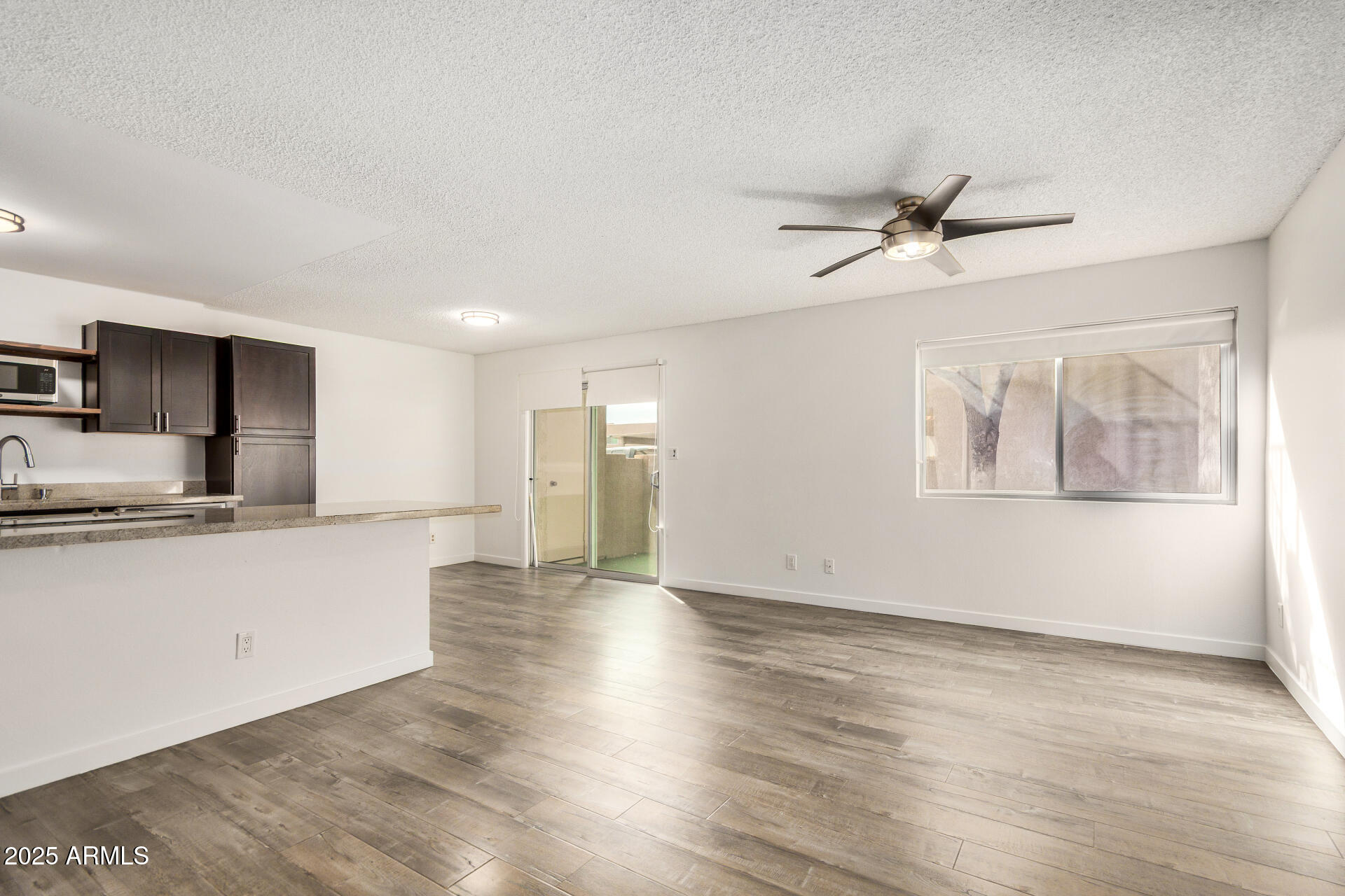 5525 East Thomas Road, Unit C4 Phoenix, AZ 85018 - Photo 10 of 34 a view of a kitchen with a sink and wooden floor